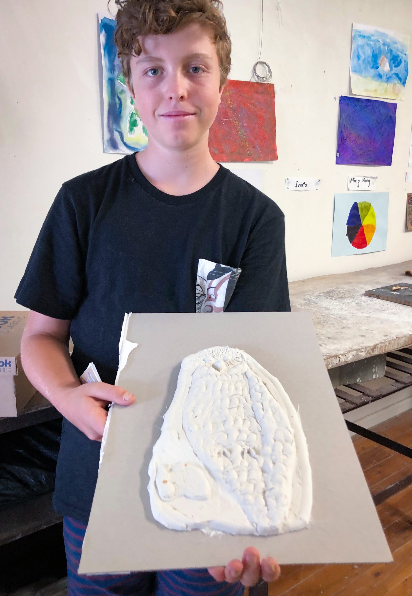 Class Artwork – Student with bas-relief animal sculpture
